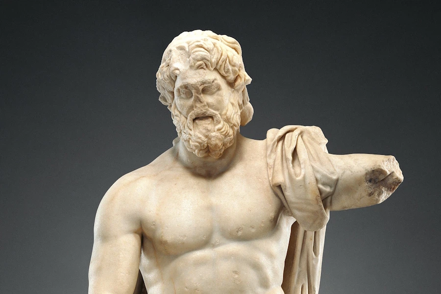 Ancient statue of Jupiter or Zeus, his arm broken off and face crumbling
