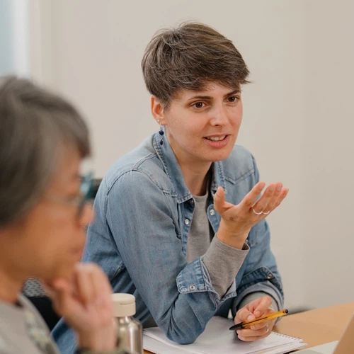 Several students in a seminar classroom.