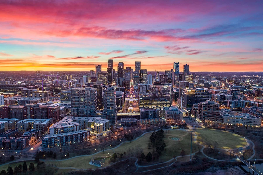 A brilliant pink and orange sunrise over the Denver skyline.