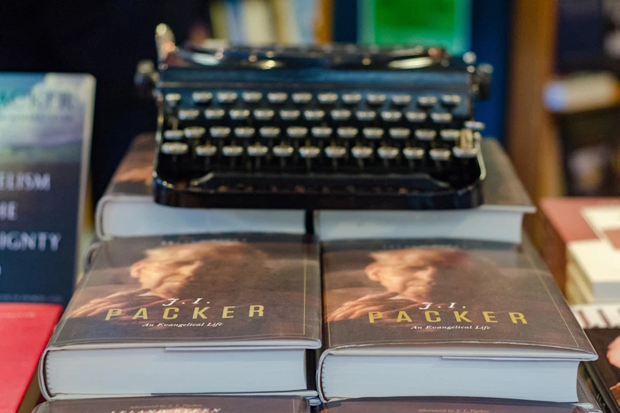 A typewriter sitting atop copies of a biography of Dr. Packer